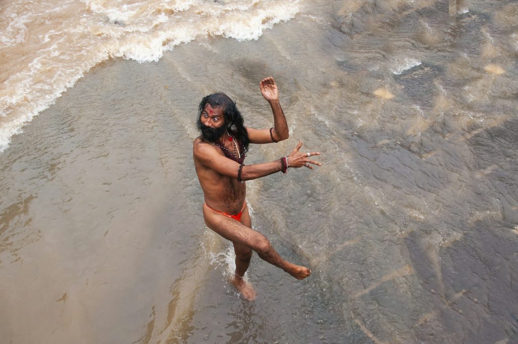 A Sadhu offering prayer in Godavari river during the Simhastha Kumbh Mela, India.