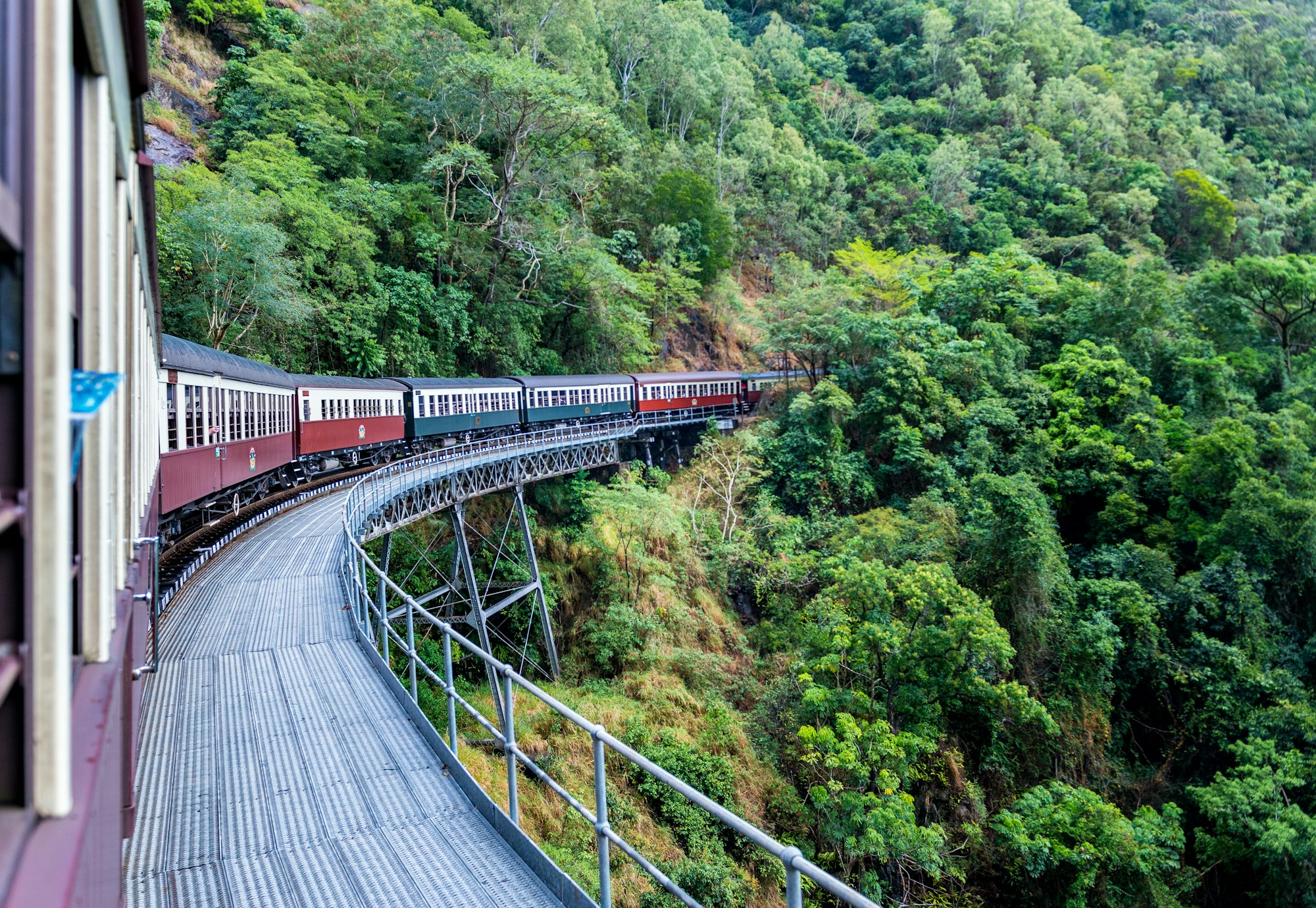 Beautiful shot of Kuranda scenic railway surrounded by green tree forests in Australia