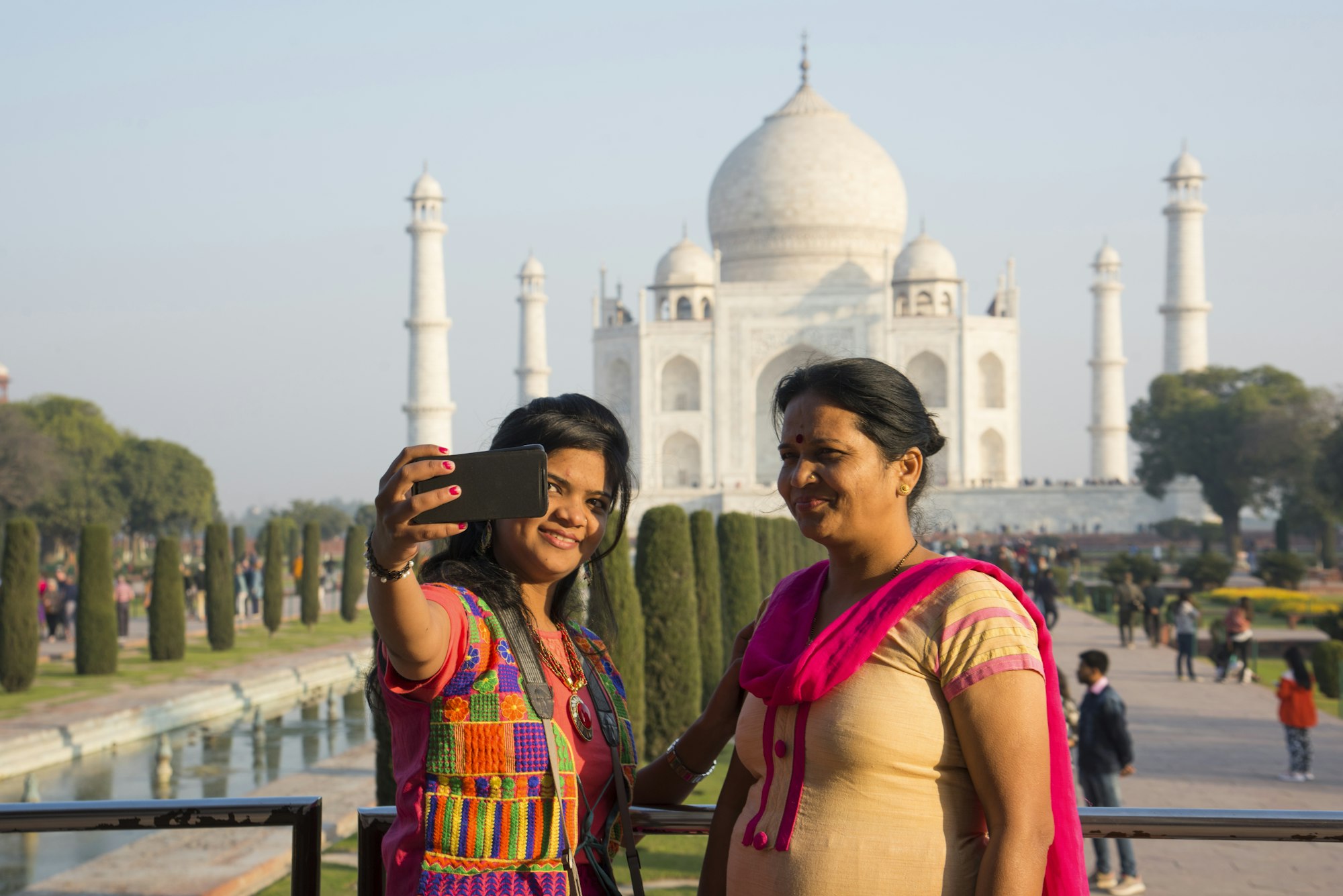 Indian mother and daughter in front of Taj Mahal.