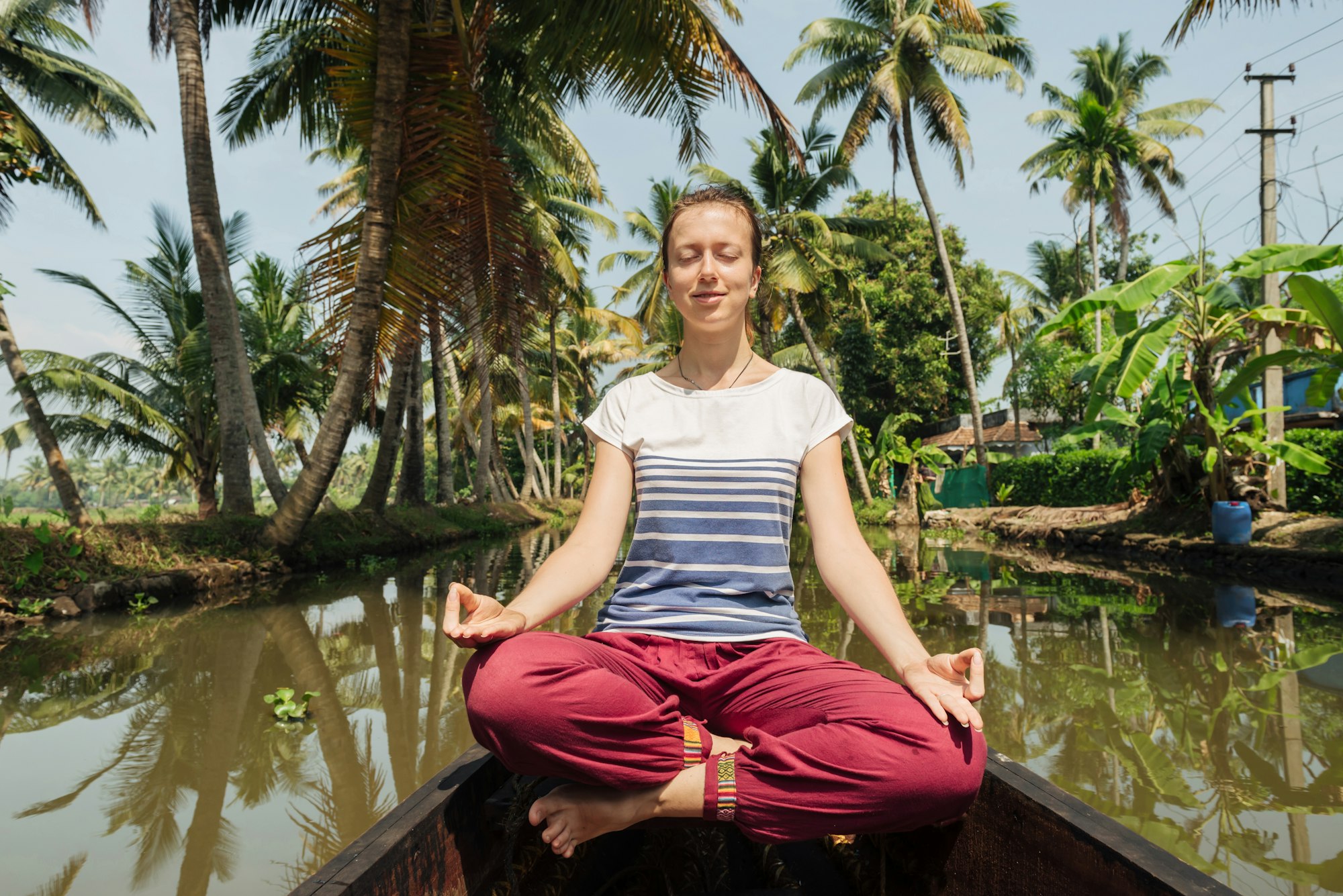 Tourist woman relaxing on Alleppey backwaters and enjoying beautiful view landscape. Kerala, India