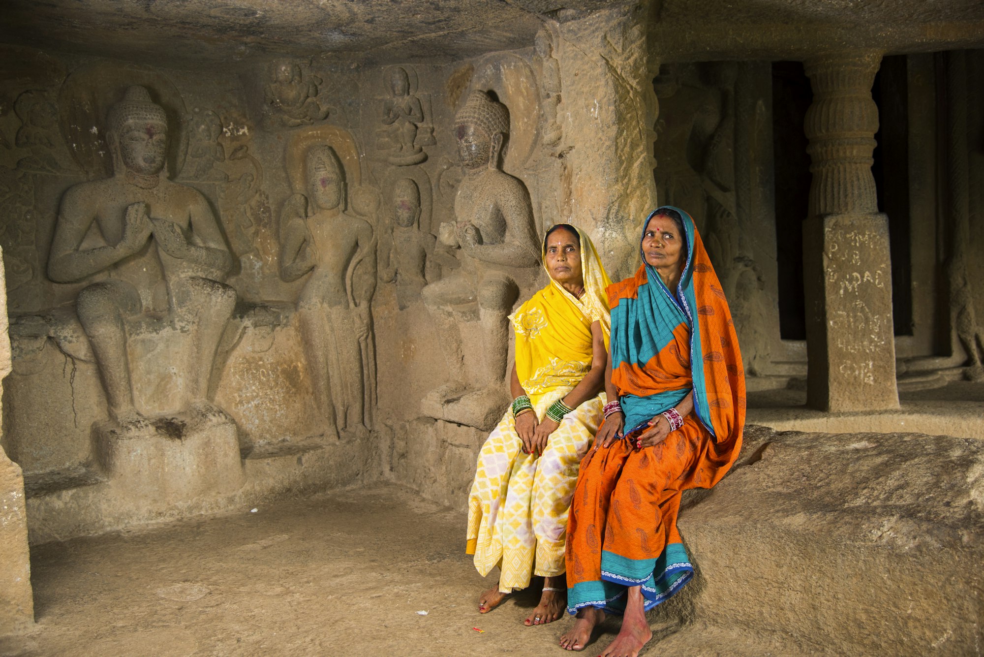 Women in buddha ancient cave, India.