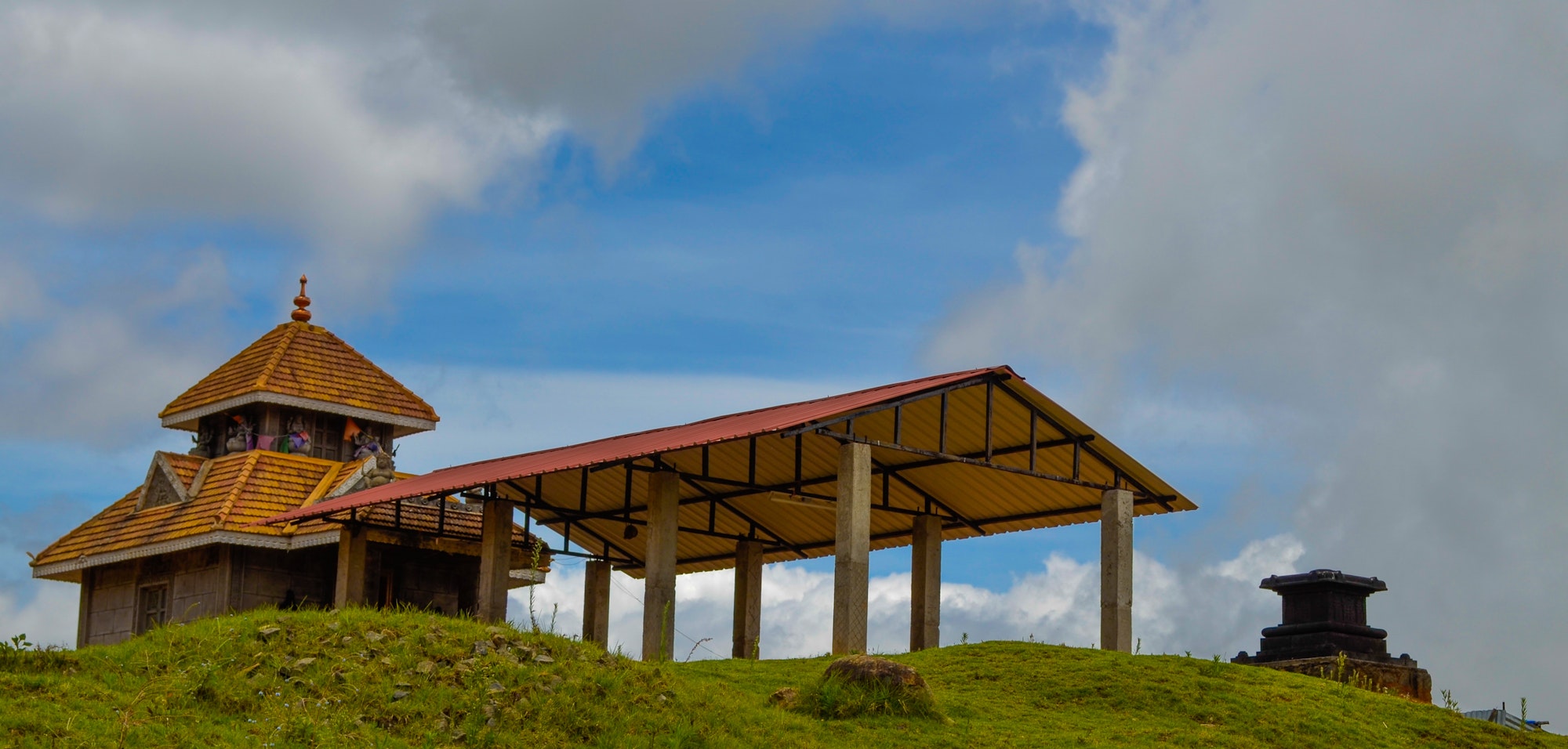 Beautiful shot of Poomparai Mahalakshmi Temple, Kodaikanal Village, India on background of sky_Kodaikanal tour packages