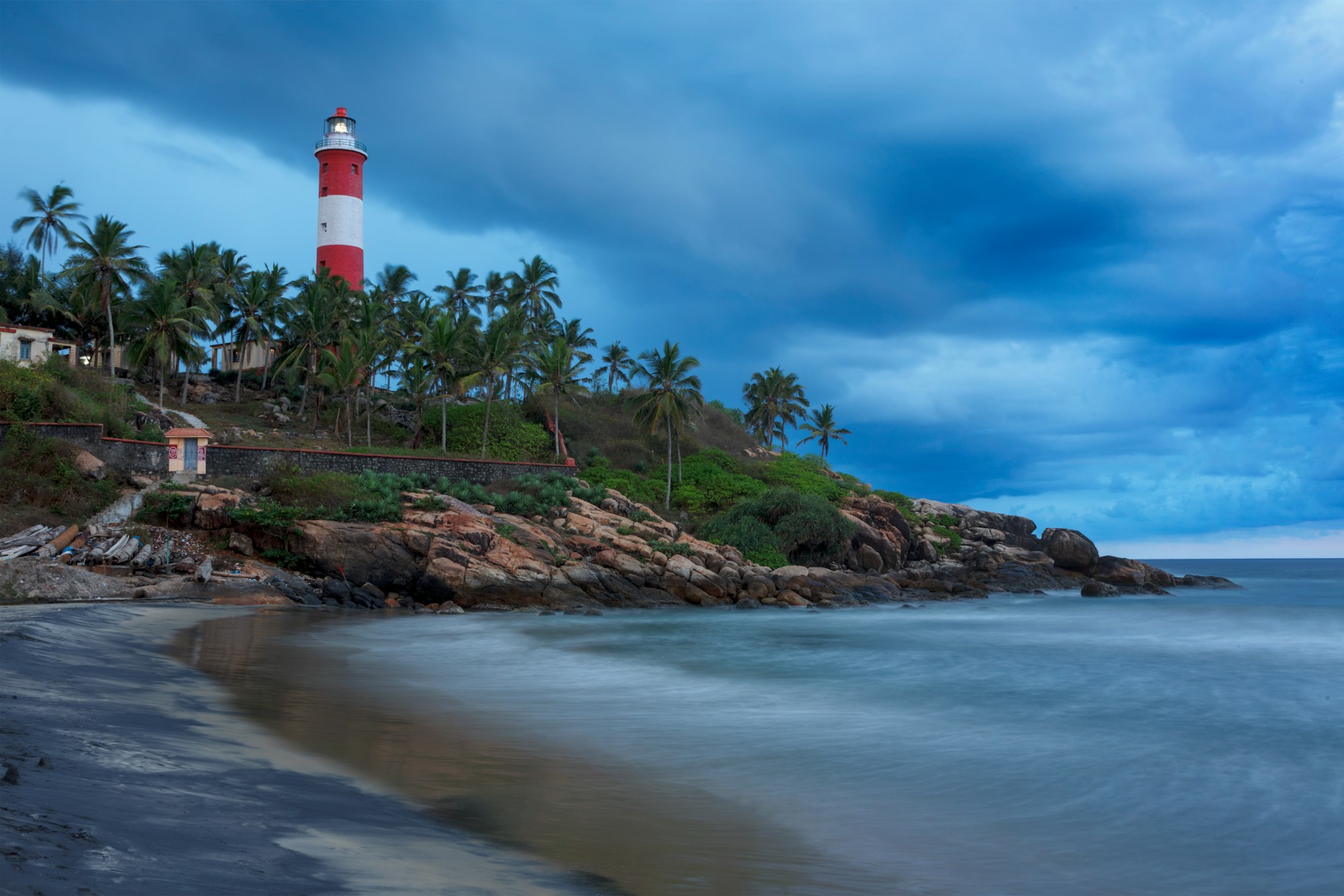 Gathering storm on beach and lighthouse on sunset. Kerala, India_4 Nights 5 Days Madurai Rameshwaram Kanyakumari Kovalam Tour Packages